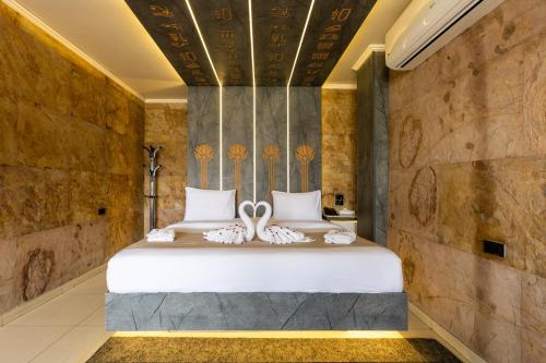 a bedroom with a bed with two white pillows at Great Pyramid Inn in Cairo