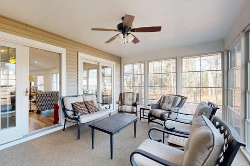 a living room with chairs and a ceiling fan at Salt Pond - 1 Heron Ct in Bethany Beach