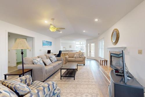 a living room with two couches and a tv at Salt Pond - 1 Heron Ct in Bethany Beach