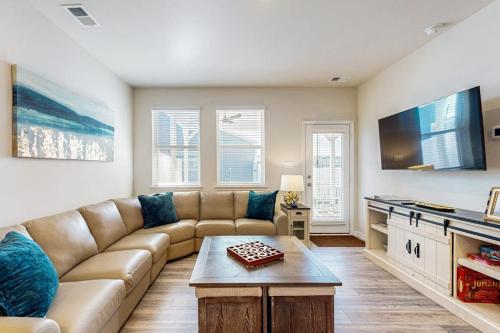 a living room with a couch and a table at Millville By The Sea in Millville