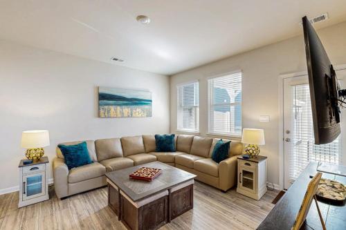 a living room with a couch and a tv at Millville By The Sea in Millville