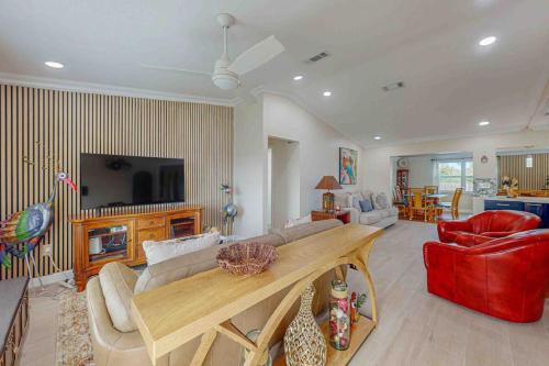 a living room with a couch and a table at Mango House in Naples