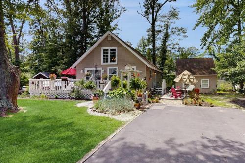 a house with a fence and a yard at Neck Village in Ocean View