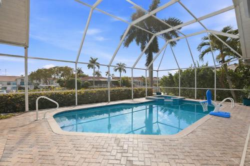 a swimming pool in the middle of a house at Marco Paradise in Marco Island