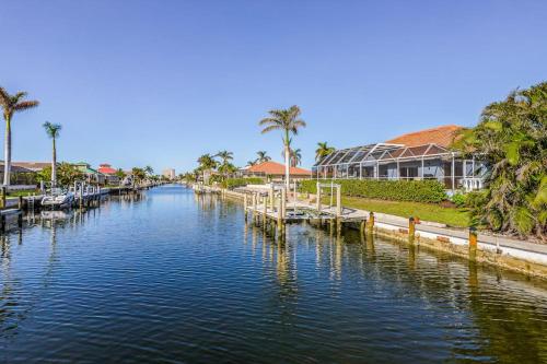 a canal of water with houses and palm trees at Marco Paradise in Marco Island