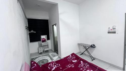 a white room with a red bed and a window at Razumi's Homestay 3 in Arau