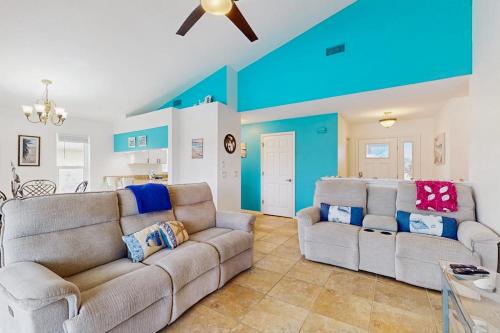 a living room with two couches and a blue wall at Waterway Whispers in Rotunda-West