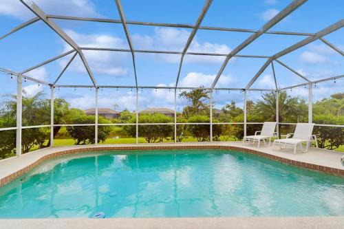 a swimming pool with two chairs and a tent at Waterway Whispers in Rotunda-West