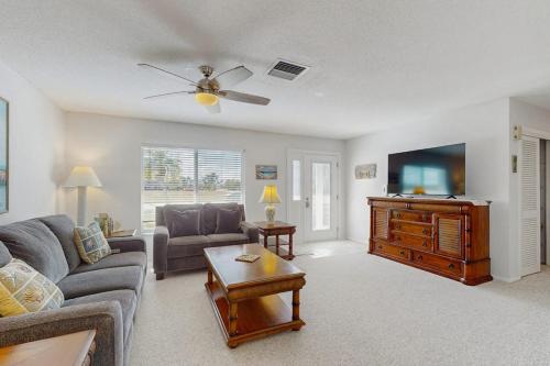 a living room with a couch and a tv at Lil Blue in Punta Gorda