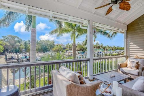 a porch with a view of the ocean and palm trees at Bocilla Breeze in Bokeelia