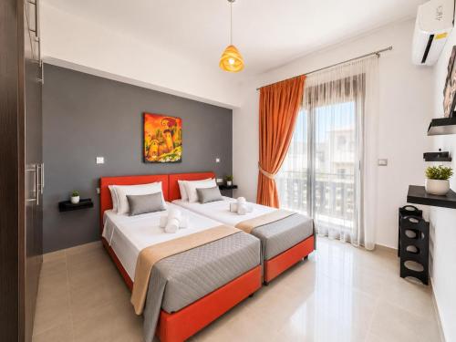 a bedroom with two beds and a large window at Rhodian Villa in Kremasti