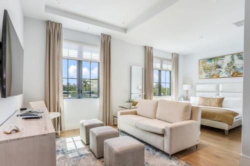 a living room with a couch and a bed at SoCe Flats 209 in Naples