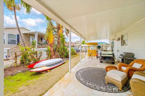 a house with a patio with a surfboard on it at Sunset Escape in Marco Island