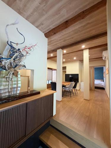 a living room and dining room with wood ceilings at 和風アンドラン in Minamiawaji