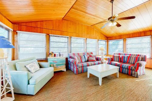 a living room with two couches and a table at The Canal -- 337 Sandpiper in Bethany Beach