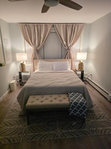 a bedroom with a large bed with a ceiling fan at Single Level Spacious Home - A JBMB Property in Middletown