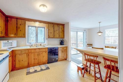 a kitchen with wooden cabinets and a counter top at Corner Cottage in Chatham