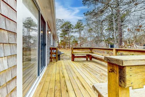 a wooden porch with a bench and a window at Corner Cottage in Chatham