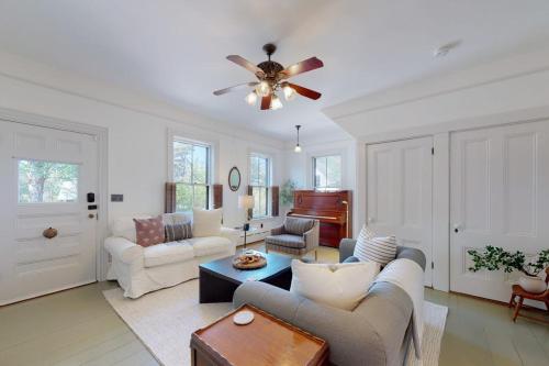 a living room with a couch and a ceiling fan at Old Mansard in West Dennis