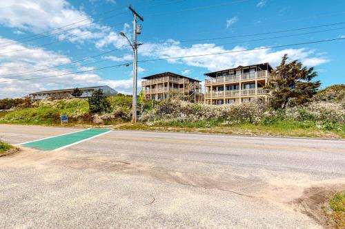 an empty street with an apartment building in the background at National Seashore Studio in Truro