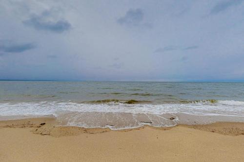 a sandy beach with the ocean in the background at Herring Brook in Eastham
