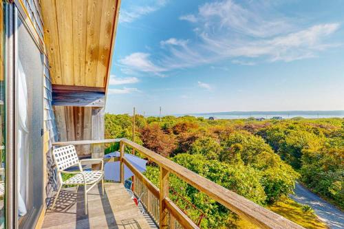 a balcony with a chair and a view of the ocean at Lobsterville Landing in Lobsterville