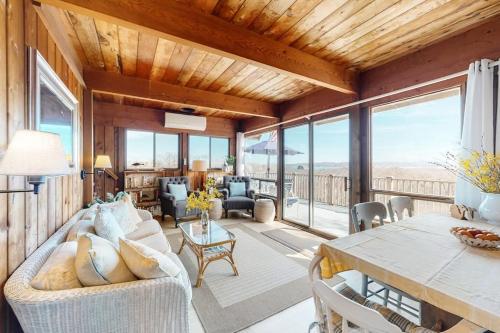 a living room with a couch and a table at Lobsterville Landing in Lobsterville