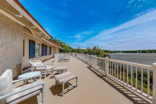 a balcony with chairs and a view of the water at Capeview Estate in Bourne