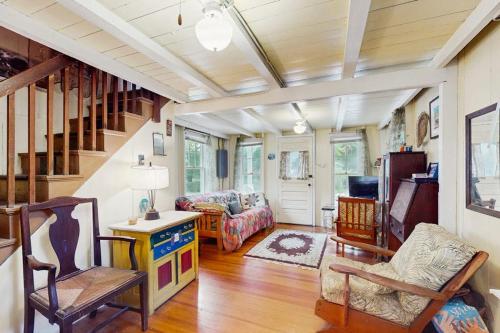 a living room with a staircase and a couch at TumbleINN in Oak Bluffs