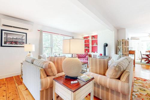 a living room with two couches and a table at Main Street Upper in Vineyard Haven