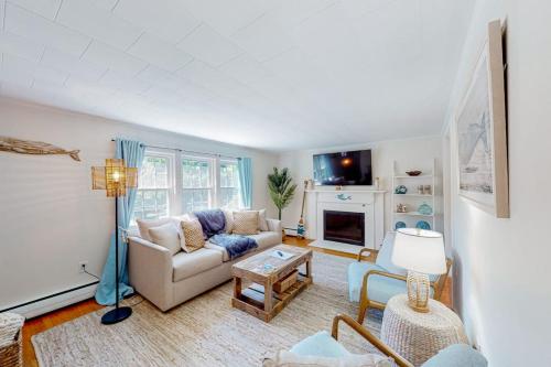 a living room with a couch and a fireplace at Downtown Seaside Serenity Retreat in Hyannis