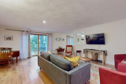 a living room with a couch and a table at Tall Pines in Wellfleet
