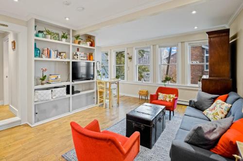 a living room with a couch and chairs and a tv at Lady Burns' Lookout in Provincetown