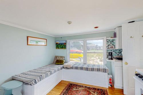 a room with a bench in a kitchen with a window at Bayview Escape in Provincetown