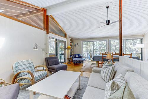 a living room with a couch and a table at Drummer Cove Retreat in Wellfleet