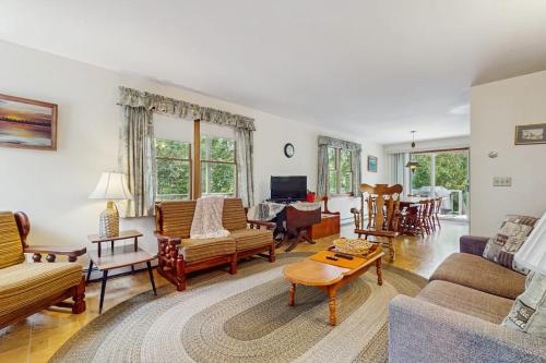a living room filled with furniture and a table at Sandpiper's Saltbox in Dennis