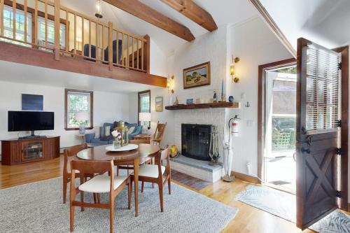 a living room with a table and a fireplace at The Lodge in Provincetown