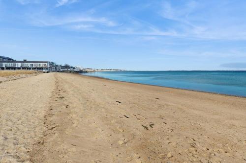 a sandy beach with a house in the background at The Buoy Room in Provincetown