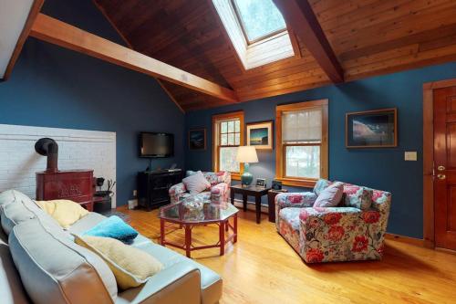 a living room with a couch and a table at Need a Bigger Boat in Edgartown