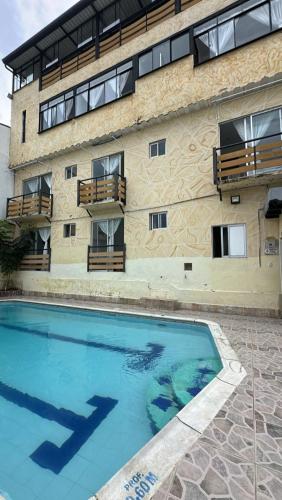 a large swimming pool in front of a building at Hotel Casa Palma in La Mesa