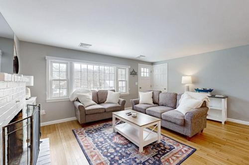 a living room with two couches and a coffee table at Champagne Dreams in Dennis