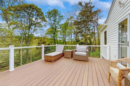 a deck with chairs and chairs on a house at The Saffron Cottage in Wellfleet