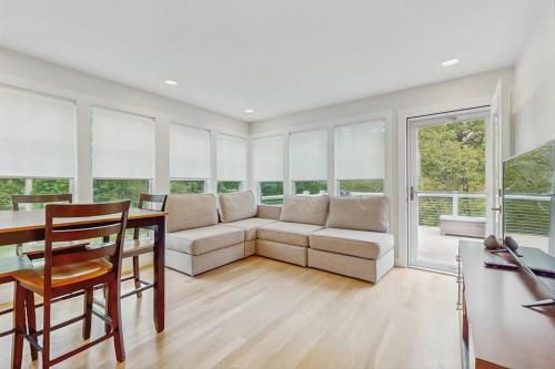 a living room with a couch and a table at The Saffron Cottage in Wellfleet