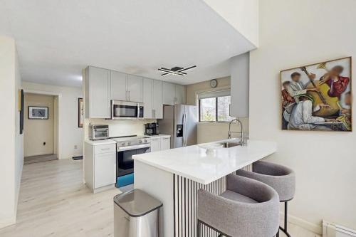 a kitchen with white cabinets and a white counter top at Twin Ponds in Oak Bluffs