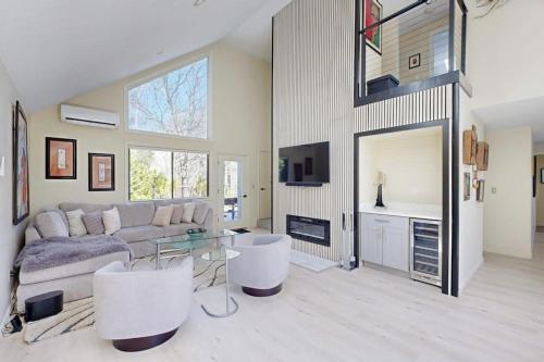 a living room with a couch and a glass table at Twin Ponds in Oak Bluffs