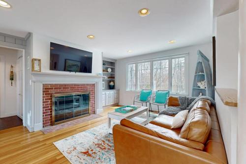 a living room with a couch and a fireplace at Cape Bliss in Yarmouth
