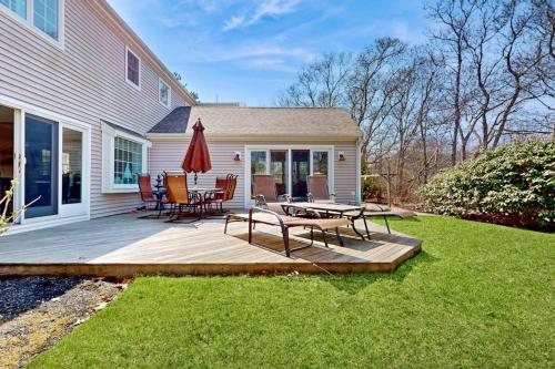 a wooden deck with a table and chairs on it at Cape Bliss in Yarmouth