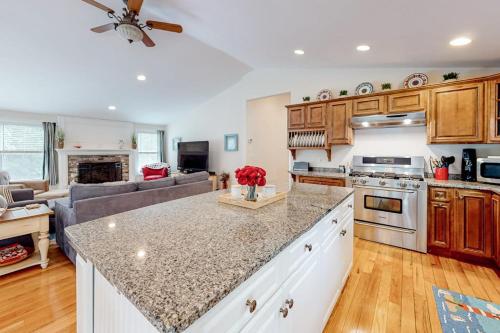 a kitchen and living room with a couch at Osterville Odyssey in Osterville