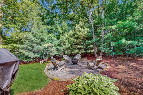 a group of chairs sitting in a garden at Sanctuary In The Woods in East Falmouth