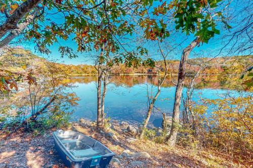 a boat sitting on the shore of a lake at Plum Paradise in Barnstable